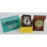 A Sekonic Auto-Lumi light meter and vintage travel alarm clock.