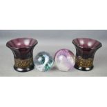 A pair of amethyst glass vases/ candle holders, and two glass paperweights; Caithness Cherry Pie