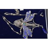 An Art Nouveau style silver and enamel dragonfly brooch with female face mask. 11.5cm high.