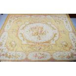 A large French Aubusson rug in gold and peach, 292 by 233cm.