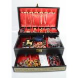 A jewellery box containing jewellery, including silver earrings, beaded necklaces, earrings,