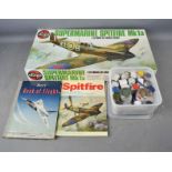 An Airfix model, parts and vintage Boys Book of Flight.