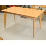 A mid-century beech dining table, with graduated legs.