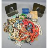 A quantity of vintage costume jewellery to include beaded necklaces, lockets, silver earrings and