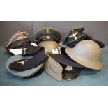 A selection of military hats and helmets.