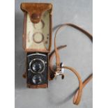 An early 20th century Rolliflex camera with case.