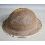 A WWII period tin helmet.
