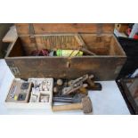 A wooden tool box containing various tools.