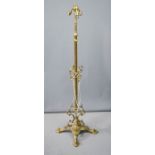 A cast brass standard lamp, with scrollwork decoration.