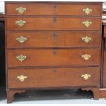 A Georgian oak secretaire chest, the two dummy drawers fold down to reveal a fitted interior of