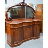 A Victorian mahogany mirror back serving table, with three shaped drawers above three cupboard