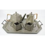 An Art Nouveau period pewter tea service, by Houndhead, hammered finish, angular form, comprising