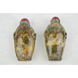 Two similar Chinese reverse painted snuff bottles, depicting landscape and figures, with Miau silver