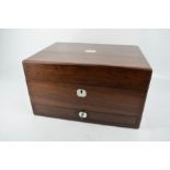 A 19th century rosewood vanity case, with fitted interior, lower drawer and key.