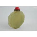 A Chinese hand carved green jade snuff bottle, with red jade stopper.