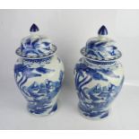 A pair of blue and white Chinese baluster jars & covers, Bearing Kangxi Qing Dynasty mark to the