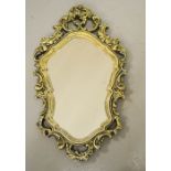 A gold painted oval carved wall mirror.