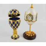 Two ornamental watch cases in the form of eggs, one in blue enamel embellished with pearls, the
