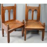 A pair of Pugin style oak gothic carved chairs.
