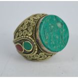 A white metal Indonesian seal ring, inset with carved stone.