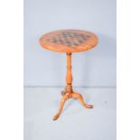 A 19th century satinwood games table, with tripod base.