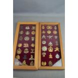 Two framed sets of cap badges.