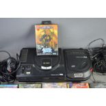 A vintage Sega Megadrive with a Mega CD attachment and a group of games.