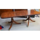 A 19th century style mahogany reproduction pedestal dining table with extra leaf, the pedestals