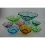 A retro coloured glass trifle bowl with matching dessert bowls, and a large fruit bowl.