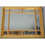 A gold painted wall mirror composed of mirrored bevel edged plates to the border, 99 by 85cm.