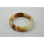 A Chinese natural jade bangle.