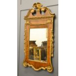 A 19th century tabernacle mirror, walnut veneered, surmounted with a carved and gilded eagle flanked