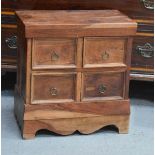 A small Indonesian chest of drawers.