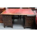 A partners desk with red leather top.