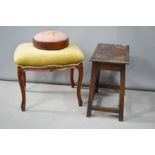 Three stools; a needlework roundel gout stool, a mahogany and green velvet upholstered stool, and