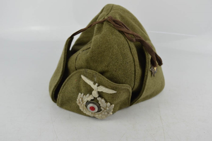 A Rare WWII German Officers Finnish winter cap with badges.