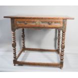 A 17th century oak side table with single drawer, bobbin turned legs and later castors, 72 by 60