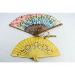 A vintage hand painted fan, and a paper painted example.