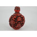 A vintage Chinese carved cinnabar style snuff bottle.