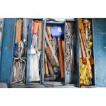 A cantilever tin tool box containing rules, spanners, screwdrivers and hammers.
