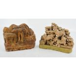 Two soapstone carvings, one depicting three dogs of fo raised on a plinth, the other depicting
