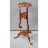 A mahogany jardiniere stand, with carved decoration, two small drawers and carved legs, 88cm high.