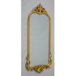 A gold painted wall mirror with C scroll and foliate design, 93 by 65cm.