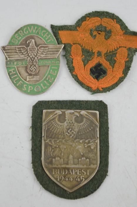 A Budapest 1944/45 Nazi uniform shield, and two military Nazi police badges.