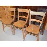 Three small antique pine kitchen chairs.