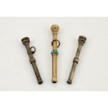 A gold (unmarked) 19th century propelling pencil set with turquoise and red glass top, 5½cm,