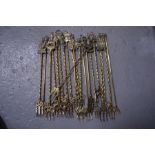 A collection of brass toasting forks, including All Saints Stamford, Lincoln imp, Peterborough and