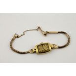 An 18ct gold cased 1930s watch, with a 9ct gold chain bracelet and safety chain, presentation