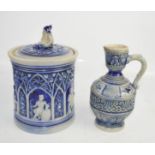 A German Simon Peter Gerz salt glazed jug, marked 5511 to the base, together with a jar and cover,