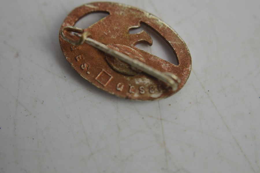 Five Nazi part badges all with makers marks and a 1937 Adolf Hitler commemorative coin - Image 4 of 6